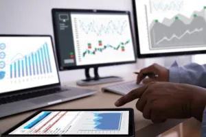 Computers and tablets on a desk displaying charts and numbers indicating increased boost in sales from compelling copywriting services in syracuse ny